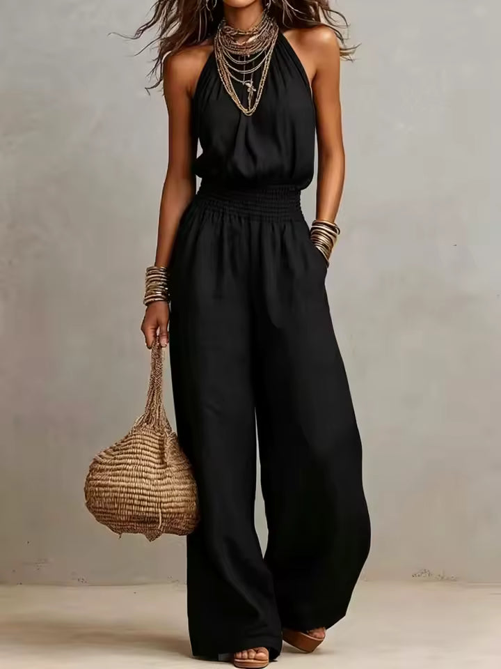 Mono mujer de espalda descubierta con escote halter y pierna ancha