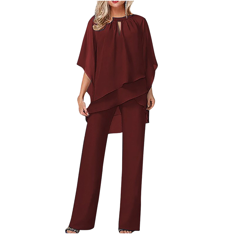 Conjunto elegante mujer con blusa asimétrica y pantalón ancho